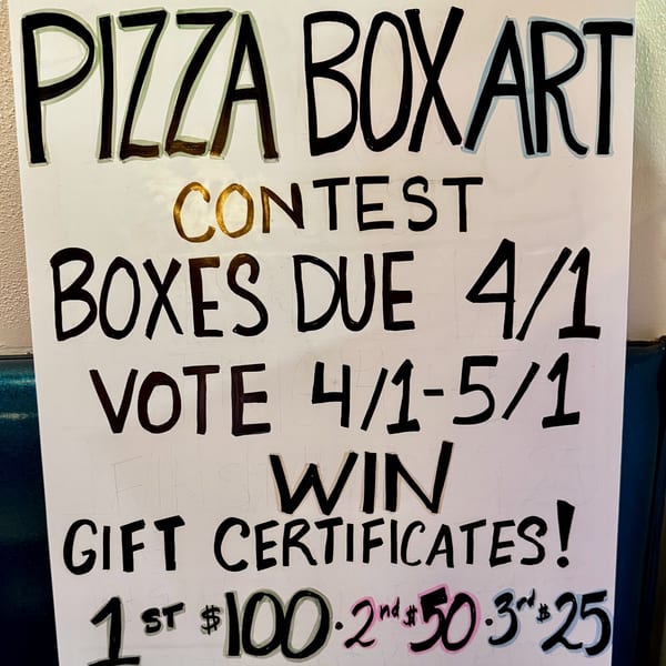 A sign announces a "Pizza Boxart Contest" with submission and voting dates, and gift certificate prizes.